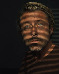 Obraz premium .Dark mysterious portrait of blond man with light blue eyes and