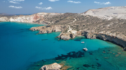 Obraz premium Aerial drone photo of beautiful volcanic emerald paradise bay and sandy beach of Tsigrado below white rock with perlite mine, Milos island, Cyclades, Greece