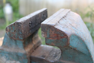 old locksmith vise in the yard of the house