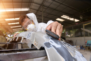 Man on a car wash polishing car with a polish machine