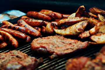 Meat and potatoes on BBQ, barbecue grill