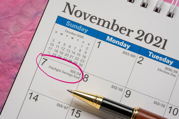 November 2021, spiral desktop calendar with the end of daylight saving time marked in red, business...
