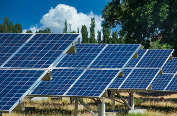 Solar power plant producing sustainable electricity and renewable energy. Solar energy to prevent climate change. Solar panels under a sunny sky.