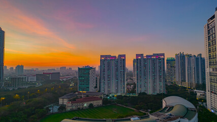 Fototapeta na wymiar Panoramic photo of Jakarta overlooking Parklands, and the city skyline with a spectacular sunset. Jakarta, Indonesia, July 28, 2021