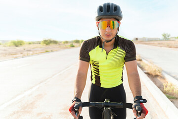 Handsome athlete practicing cycling outdoors