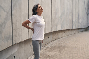 Aged active woman feeling pain in back