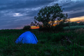 tent at sunset in the wild