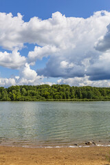 Beautiful natural summer landscape with picturesque lake Senezh and cloudy sky. Moscow region, Russia