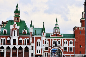 The building is in the Dutch style of red and white brick with a green roof. Russia Yoshkar Ola 01.05.2021. High quality photo