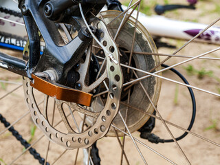 Obraz premium Rear disc brake on a bicycle, perforated, cable brake system