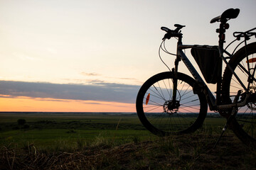 sunset photographed through bike details, front and background blurred with bokeh effect
