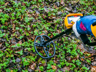Metal detector close-up on field work, treasure hunting and archaeological sites