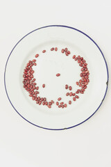 Red beans on white enamel plate