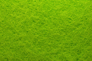 Textile. Background from green material. Enlarged spongy fibers. Sponge texture. Close up