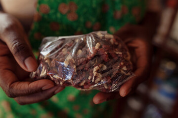 Raw red walnuts for bread making being held by a black woman