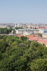Fototapeta na wymiar Panoramic top view of St. Petersburg Russia with the roofs of historical buildings and the green foliage of trees and a space to copy on a sunny summer day