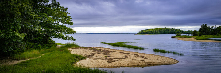 Seascape over Monk Park beach and Islands under dramatic clouds on Cape Cod