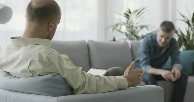 Man having a therapy session with a professional psychologist