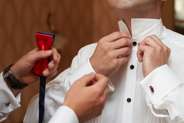 Help in dressing the groom