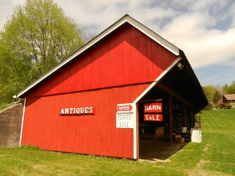 A countryside barn advertises antiques for sale, May 2015.