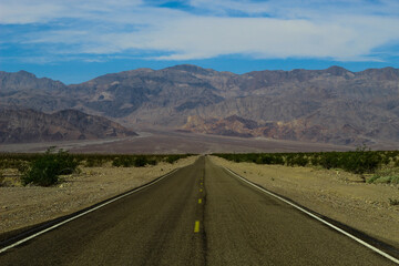 deserted road leading to the mountains