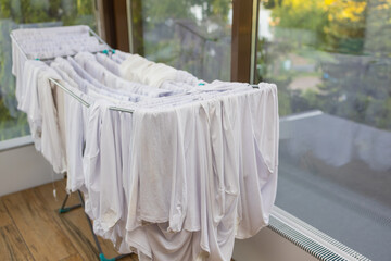 Fototapeta na wymiar Laundry Drying clothes outdoors with Sun at the Balcony condominium.