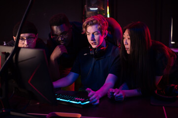 Players of the esports team gathered together in the computer club and watch the stream from the...