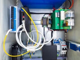 Cabinet with electrical and network equipment. Cabinet with electrical equipment from the inside. Electrical appliances and wires inside a metal cabinet. Concept - selling electric appliances