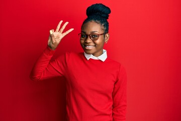 Young african american woman wearing casual clothes and glasses showing and pointing up with fingers number three while smiling confident and happy.