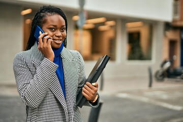 Young african american businesswoman smiling happy talking on the smartphone at the city.