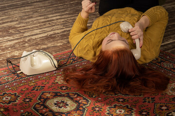  young woman with red hair with phone on the floor lifestyle smile beauty