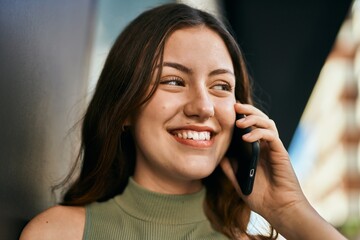 Young caucasian girl smiling happy talking on the smartphone at the city.