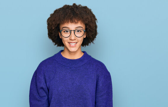 Young hispanic girl wearing casual winter sweater and glasses with a happy and cool smile on face. lucky person.