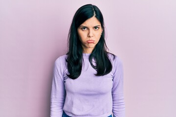 Young hispanic woman wearing casual clothes depressed and worry for distress, crying angry and afraid. sad expression.