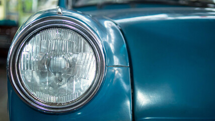 Headlight of an old car, close-up of a round headlight.