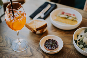A table topped with plates of food on a plate and cocktail