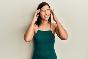 Young latin woman wearing casual clothes suffering from headache desperate and stressed because...