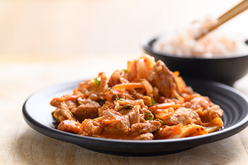 Korean food, Stir-fried kimchi cabbage with pork eating with cooked rice by chopsticks