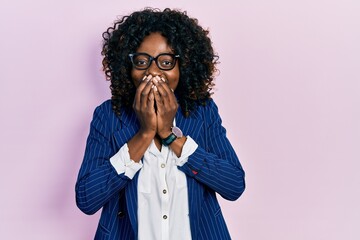 Young african american woman wearing business clothes and glasses laughing and embarrassed giggle...