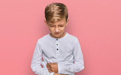 Little caucasian boy kid wearing casual clothes with hand on stomach because indigestion, painful...