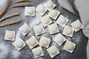 Homemade uncooked ravioli on grey table, flat lay