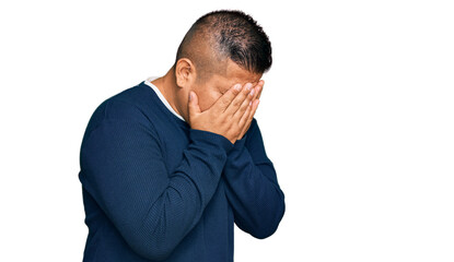 Young latin man wearing casual clothes with sad expression covering face with hands while crying. depression concept.