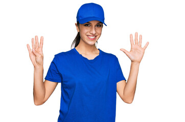 Young hispanic girl wearing delivery courier uniform showing and pointing up with fingers number nine while smiling confident and happy.