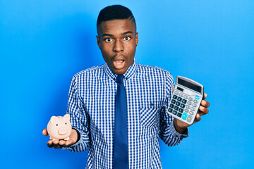 Young african american man calculating money savings afraid and shocked with surprise and amazed...