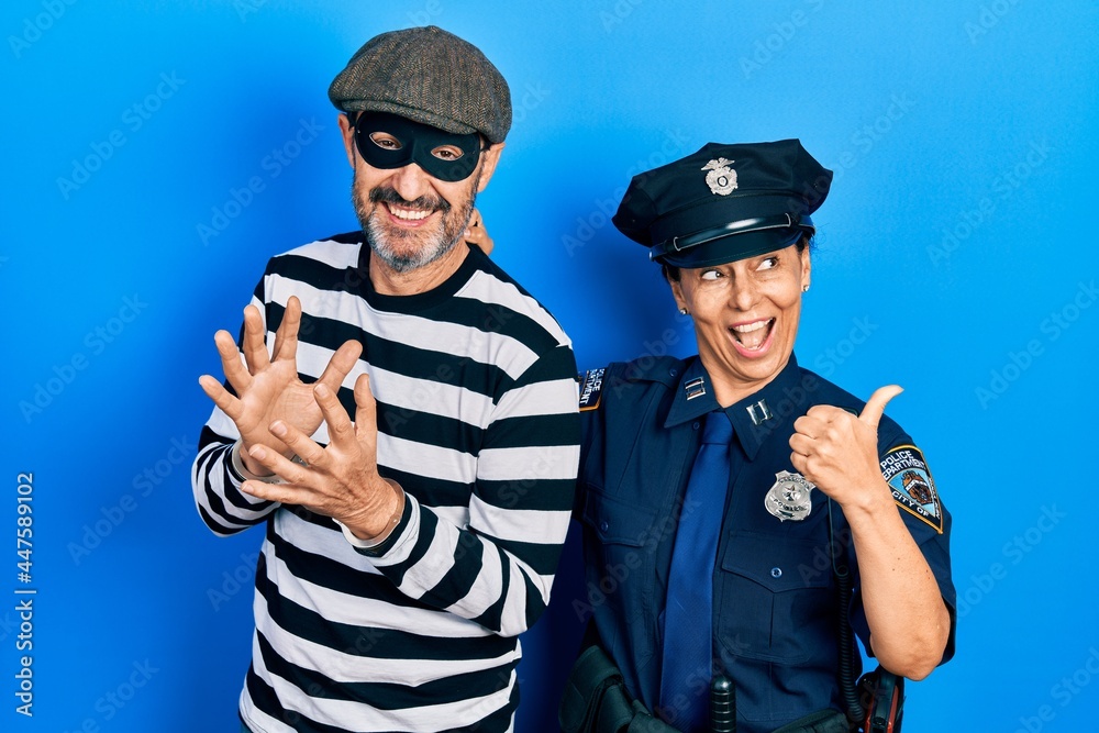 Sticker middle age couple of hispanic woman and man wearing thief and police uniform smiling with happy face