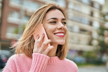 Young caucasian girl smiling happy talking on the smartphone at the city.