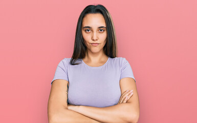 Fototapeta premium Young hispanic woman wearing casual clothes skeptic and nervous, disapproving expression on face with crossed arms. negative person.