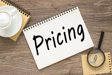 Pricing, text on wood table, on white paper