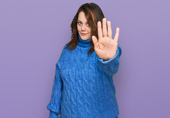 Young plus size woman wearing casual clothes doing stop sing with palm of the hand. warning expression with negative and serious gesture on the face.