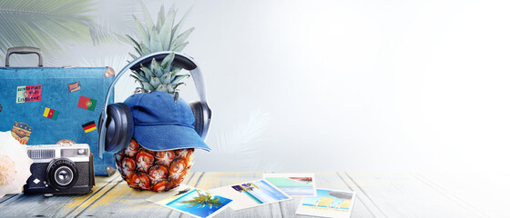 Nautical concept with palm leaf, beach hat, seashells and pineapple.